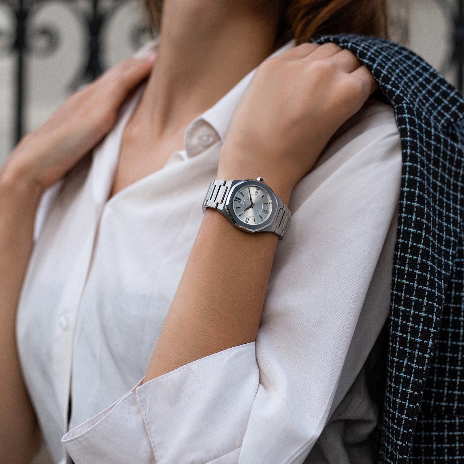 Livia Silver watch featuring bold Roman numerals, square stones, and a multi-link bracelet strap with a butterfly clasp.