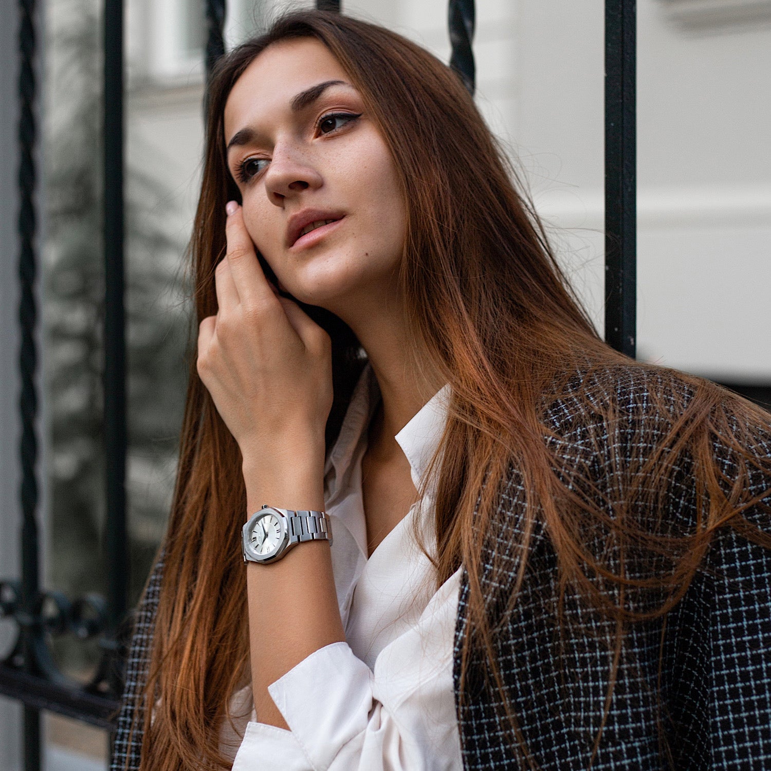 Livia Silver watch featuring bold Roman numerals, square stones, and a multi-link bracelet strap with a butterfly clasp.