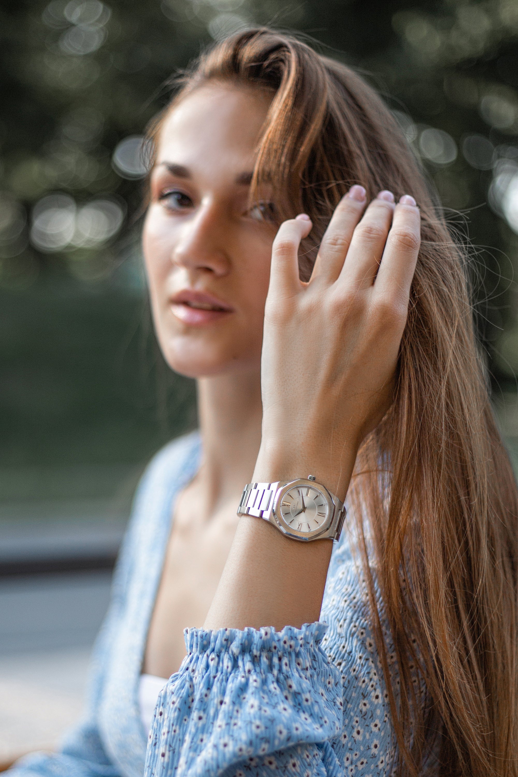 Livia Silver watch featuring bold Roman numerals, square stones, and a multi-link bracelet strap with a butterfly clasp.