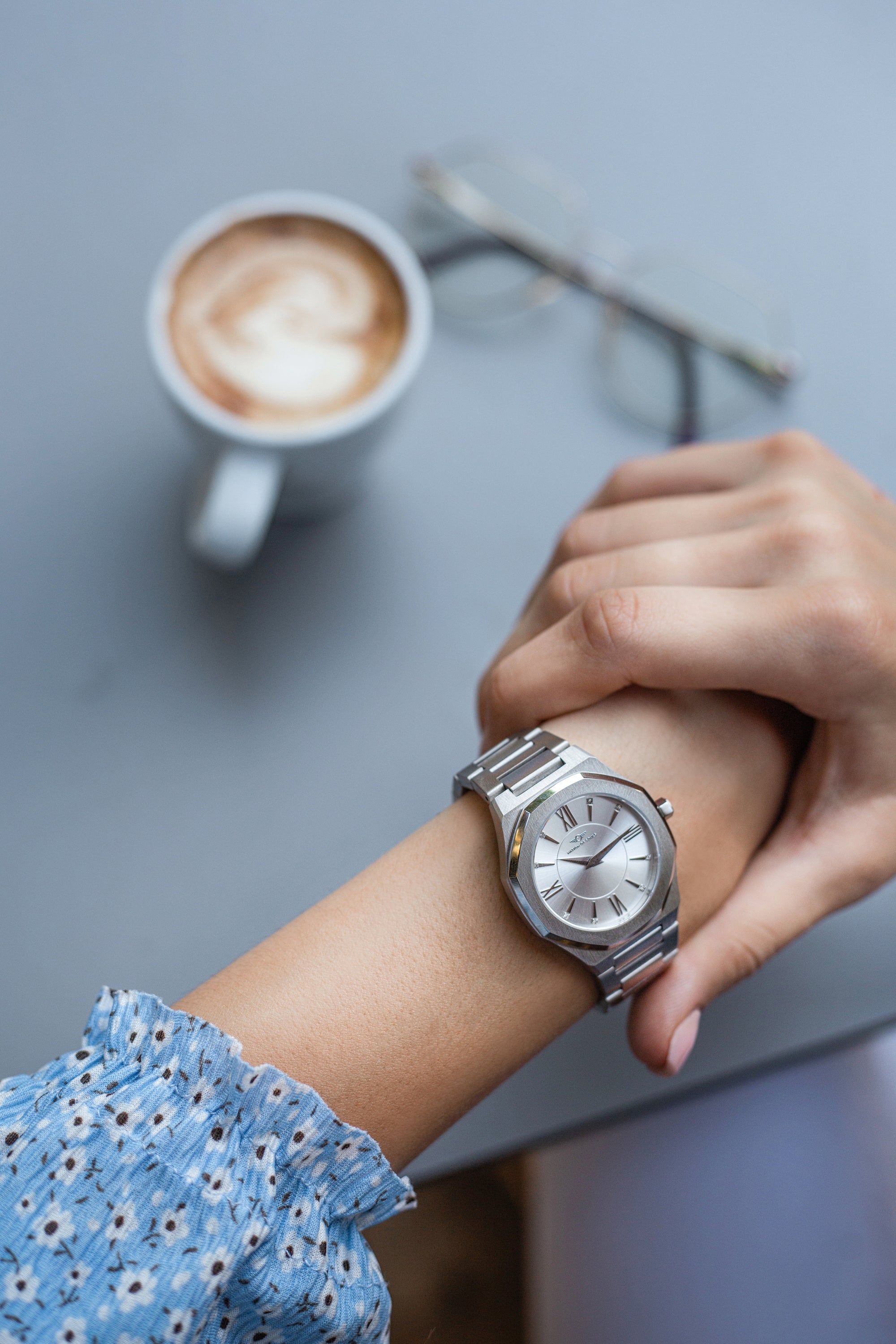 Livia Silver watch featuring bold Roman numerals, square stones, and a multi-link bracelet strap with a butterfly clasp.