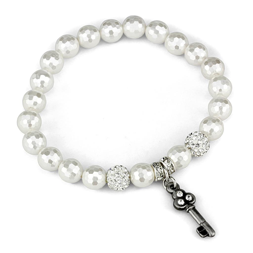 Antique silver brass bracelet featuring a white synthetic glass bead, showcasing intricate craftsmanship and elegant design.