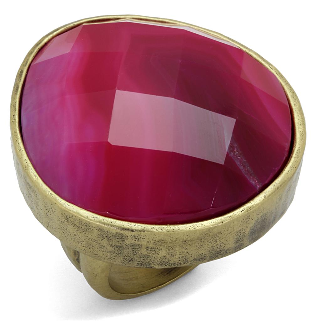 Antique copper brass ring featuring a vibrant fuchsia synthetic onyx stone, showcasing intricate craftsmanship and elegant design.