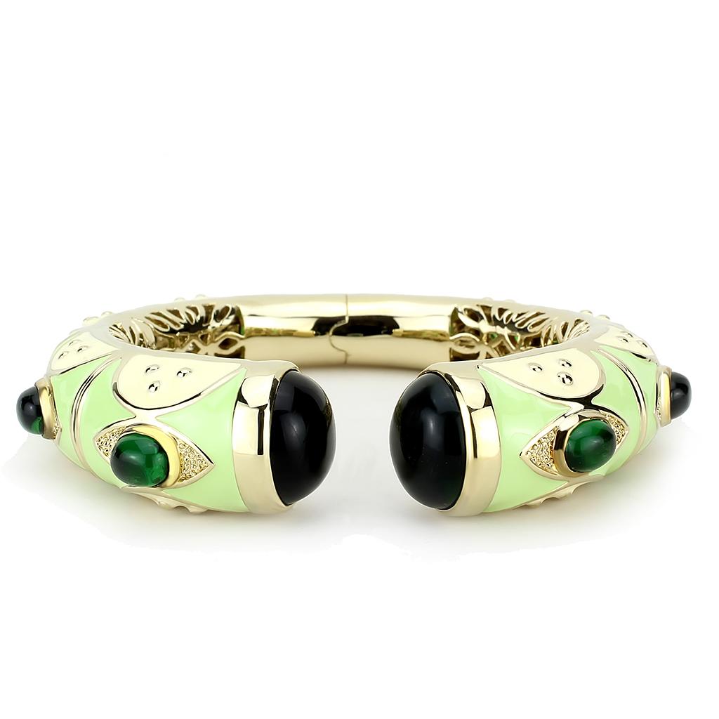 Gold brass bangle featuring a vibrant synthetic emerald centerpiece, elegantly designed for stylish wear.