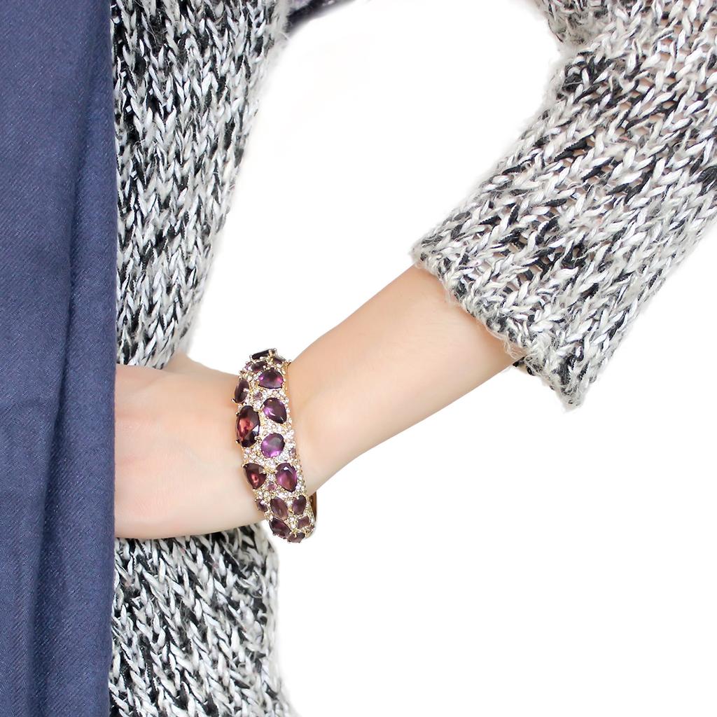 Gold brass bangle featuring a synthetic Amethyst stone, elegantly designed for stylish wear.