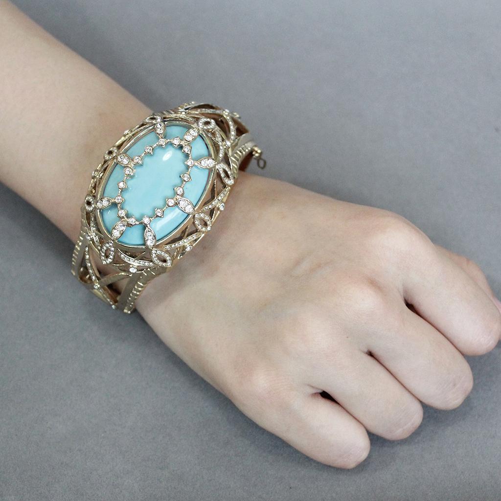 Elegant LO4348 Gold Brass Bangle featuring a vibrant sea blue synthetic stone, perfect for stylish accessorizing.