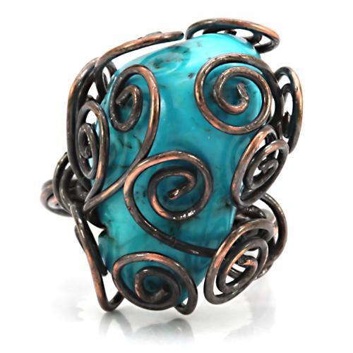 Antique tone brass ring featuring a vibrant synthetic turquoise stone, showcasing intricate details and a vintage design.