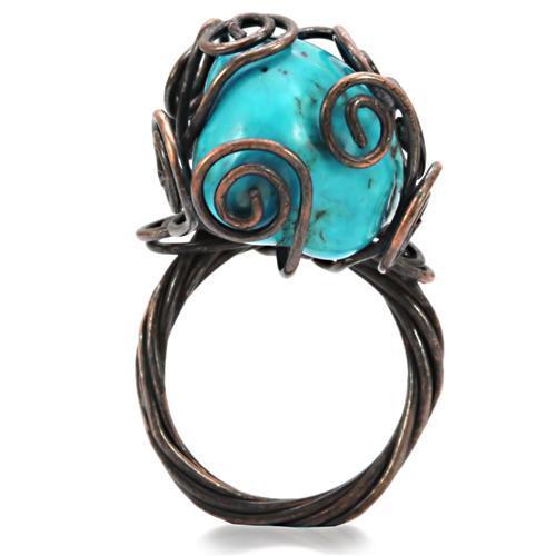 Antique tone brass ring featuring a vibrant synthetic turquoise stone, showcasing intricate details and a vintage design.