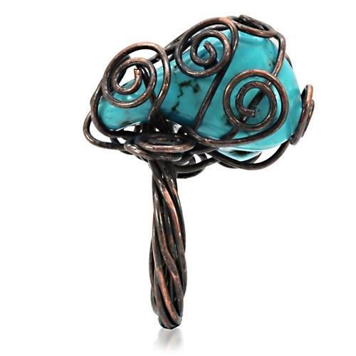 Antique tone brass ring featuring a vibrant synthetic turquoise stone, showcasing intricate details and a vintage design.