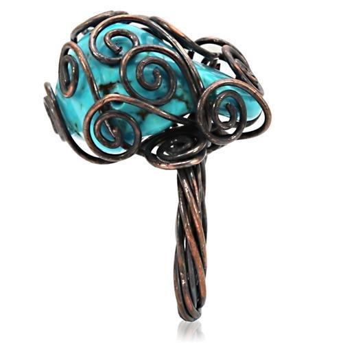 Antique tone brass ring featuring a vibrant synthetic turquoise stone, showcasing intricate details and a vintage design.