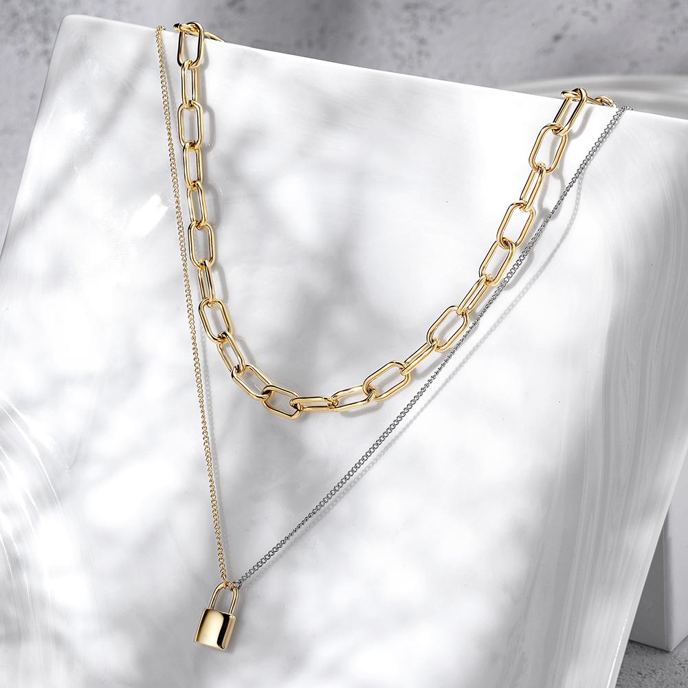 A stylish layered necklace featuring a lock pendant, crafted from surgical stainless steel with a gold finish.