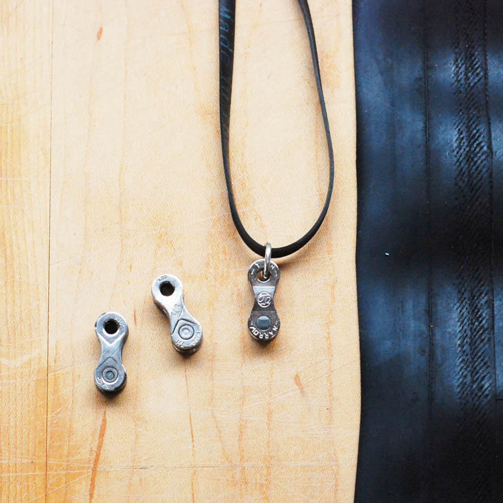 Lone Rider Recycled Bike Chain Pendant Necklace displayed in a luxury gift box, showcasing its unique design and eco-friendly materials.