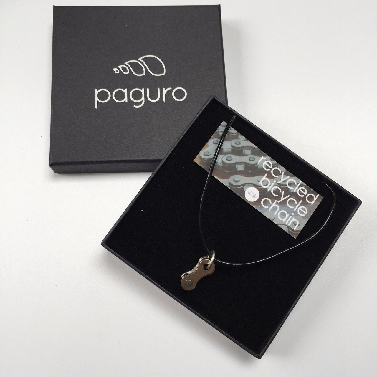 Lone Rider Recycled Bike Chain Pendant Necklace displayed in a luxury gift box, showcasing its unique design and eco-friendly materials.