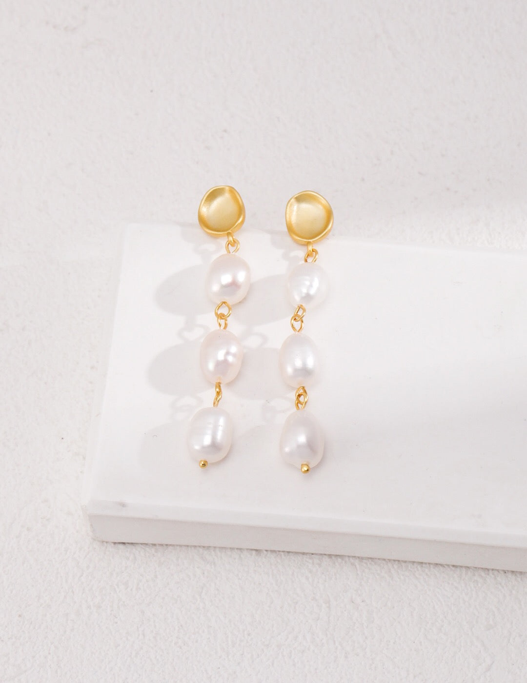 Elegant Long Baroque Pearls Dangle Earrings featuring natural pearls and gold vermeil, showcasing their unique shapes and luxurious design.