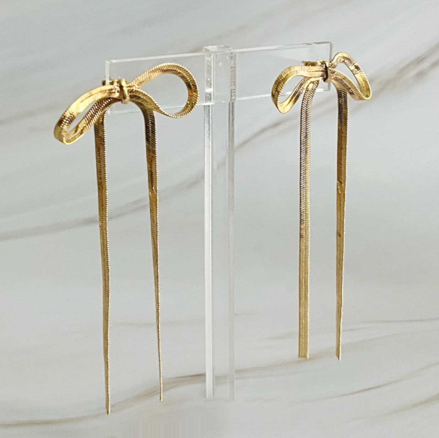 Elegant Long Drop Bow Earrings in 18k gold plated brass, showcasing a unique elongated design.