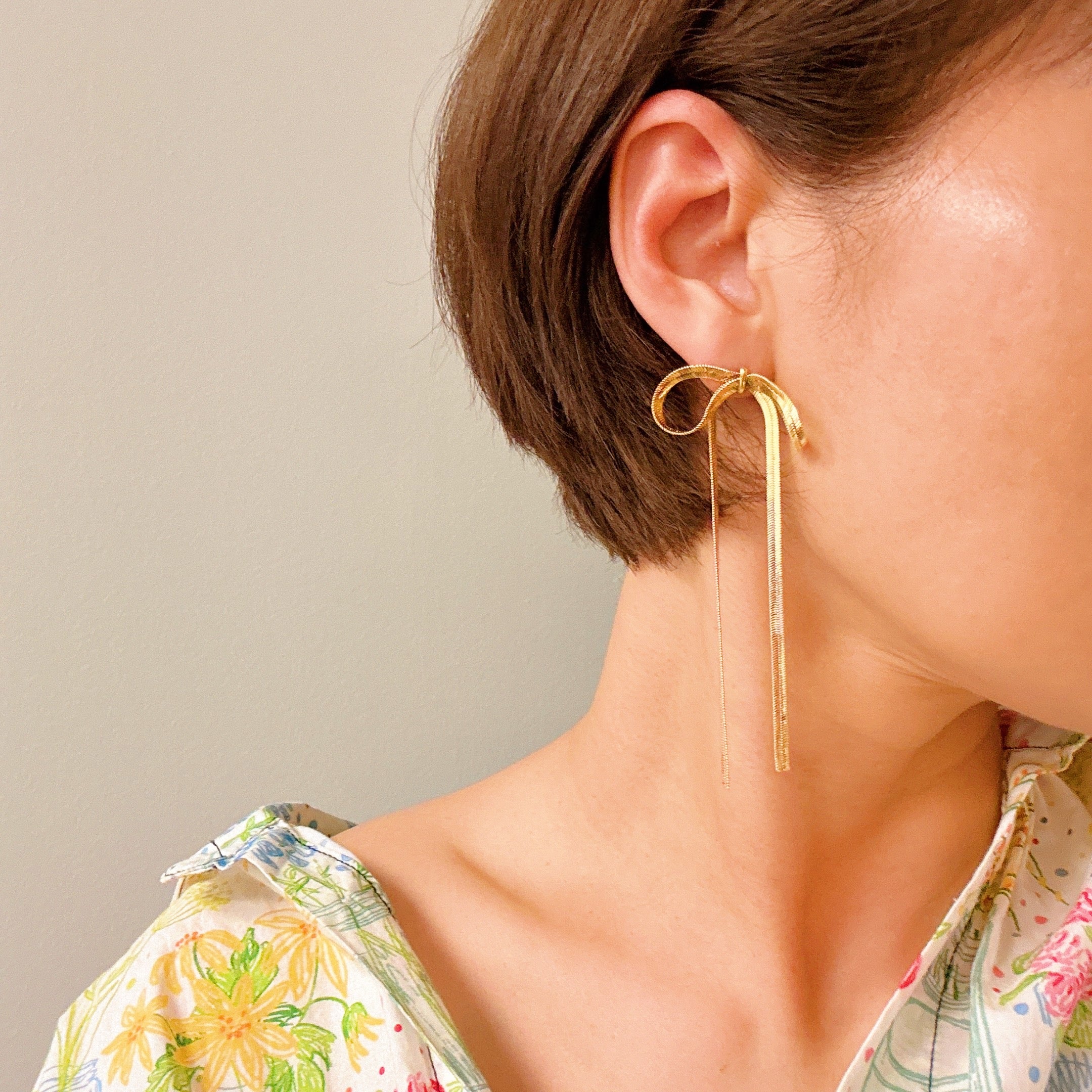 Elegant Long Drop Bow Earrings in 18k gold plated brass, showcasing a unique elongated design.