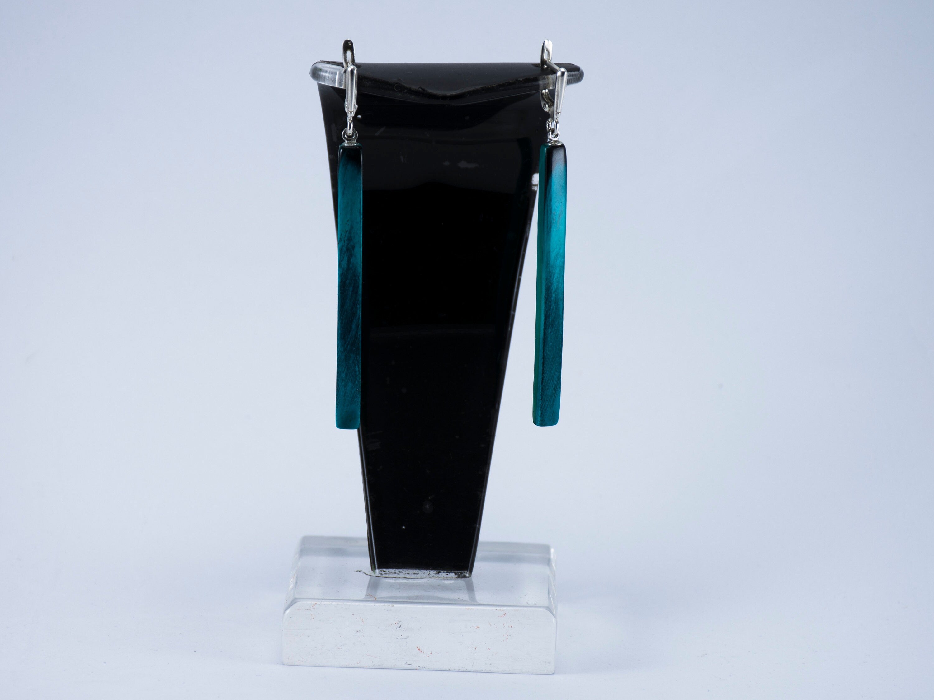 Handmade long dangle earrings made from natural buffalo horn, featuring a unique green color and polished surface, secured with silver English locks.