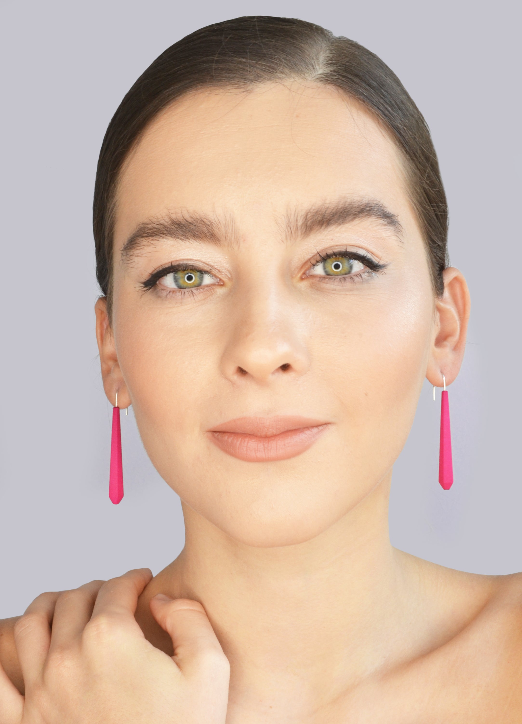 Long Pentagon Earrings in vibrant colors, featuring a geometric design with sterling silver hooks, displayed in a fabric pouch.