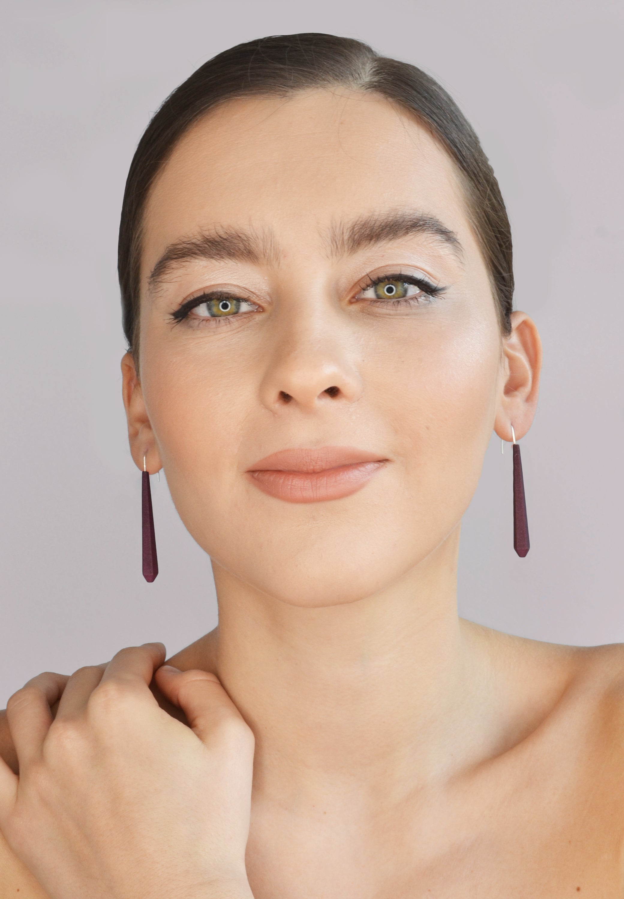 Long Pentagon Earrings in vibrant colors, featuring a geometric design with sterling silver hooks, displayed in a fabric pouch.