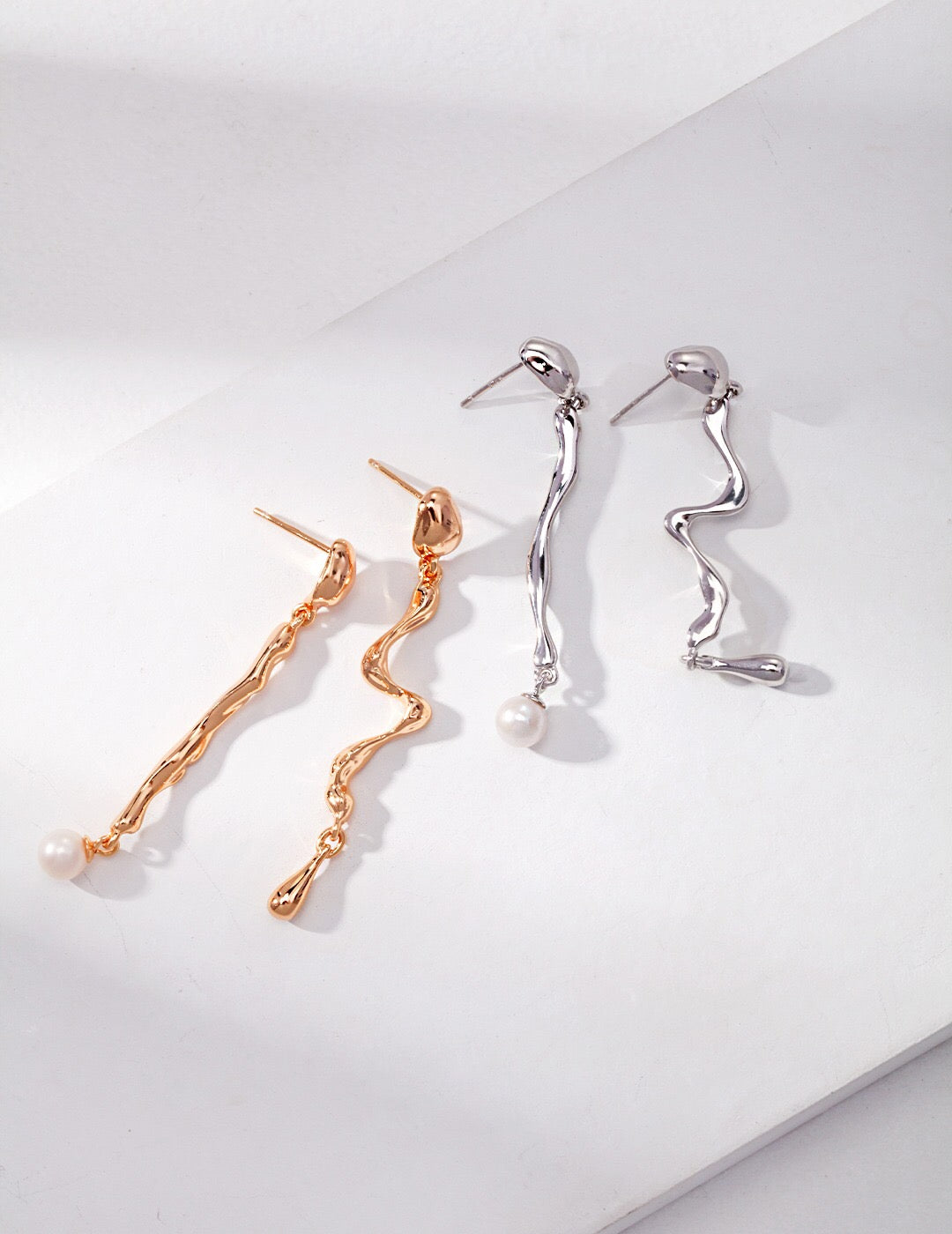 Long Wavy Drop Pearl Asymmetrical Earrings featuring freshwater pearls and gold vermeil, elegantly designed for a stylish look.