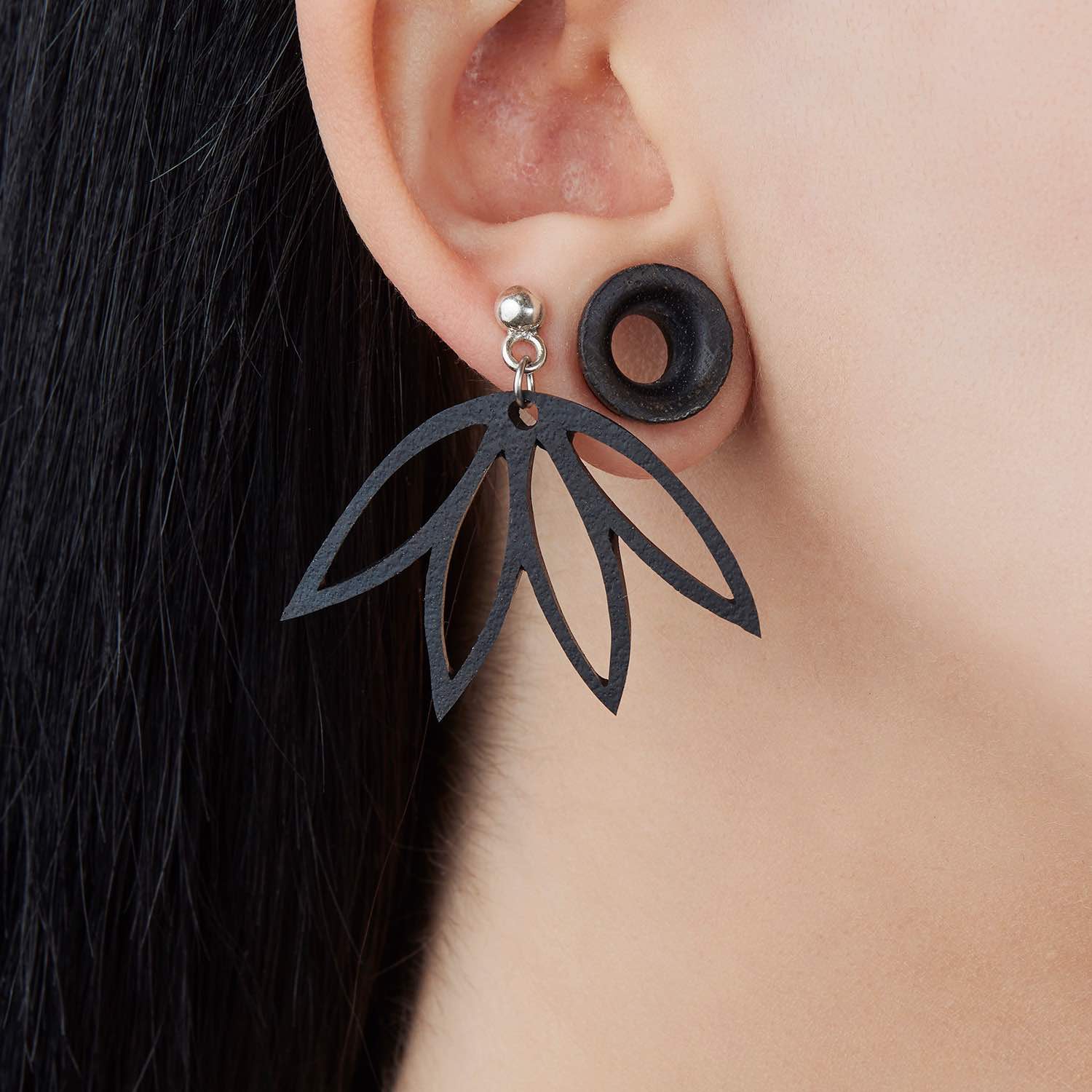 Elegant Lotus Recycle Rubber Earrings made from reclaimed rubber, featuring sterling silver studs, displayed in a luxury gift box.