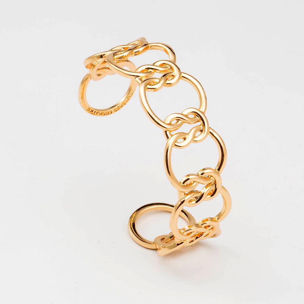 Elegant Love Knot Bracelet in 18k gold plating, symbolizing eternal love, displayed on a soft fabric background.