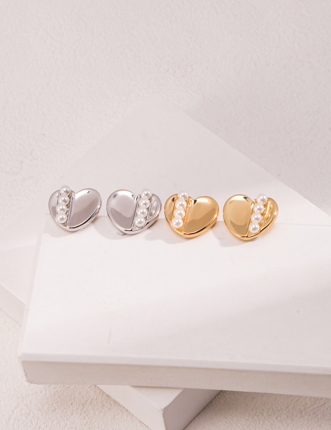 Handmade Love Pearl Stud Earrings featuring artificial pearls and gold vermeil, elegantly displayed in a jewelry pouch.