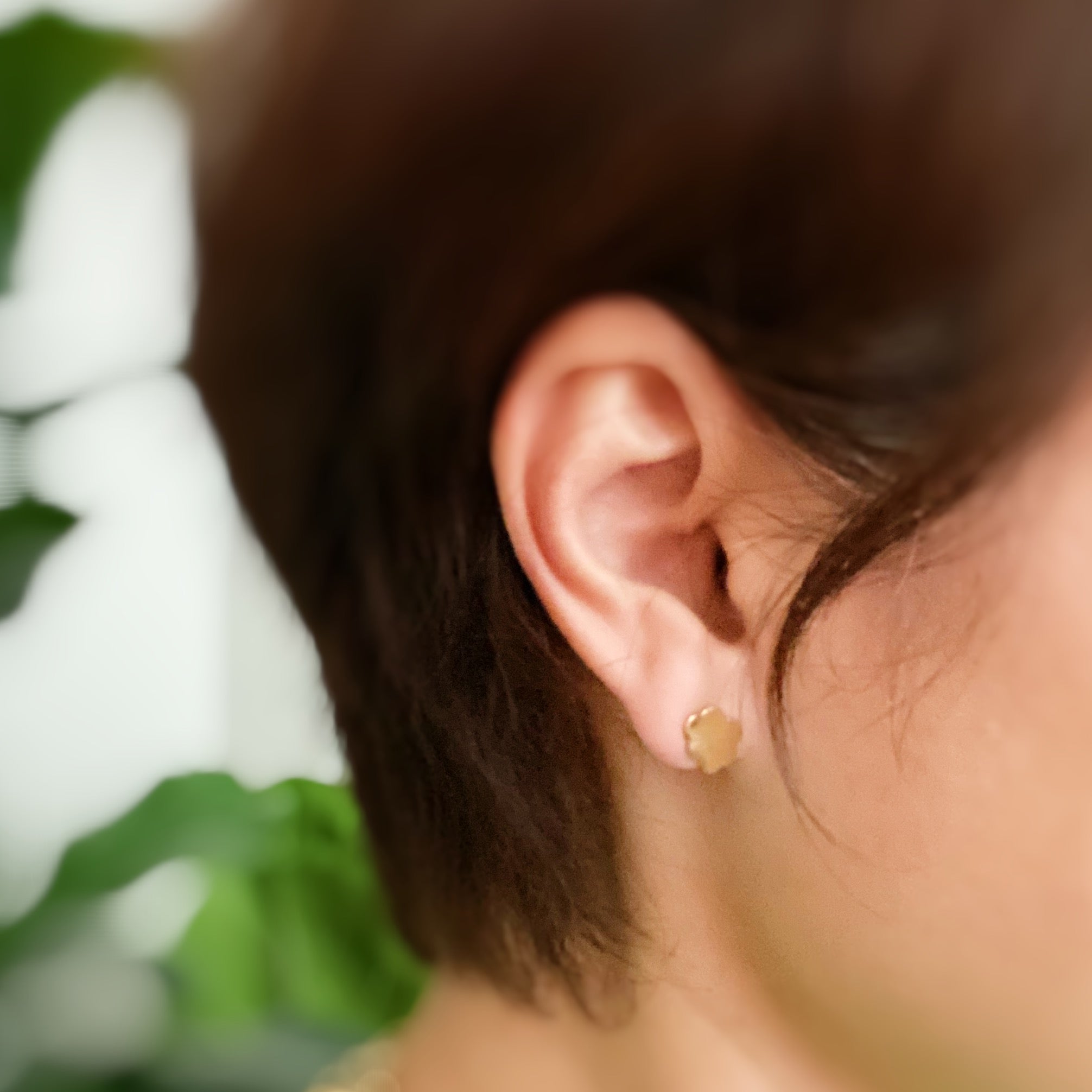 A set of four delicate stud earrings in unique shapes, showcasing 18k gold plating and premium craftsmanship.