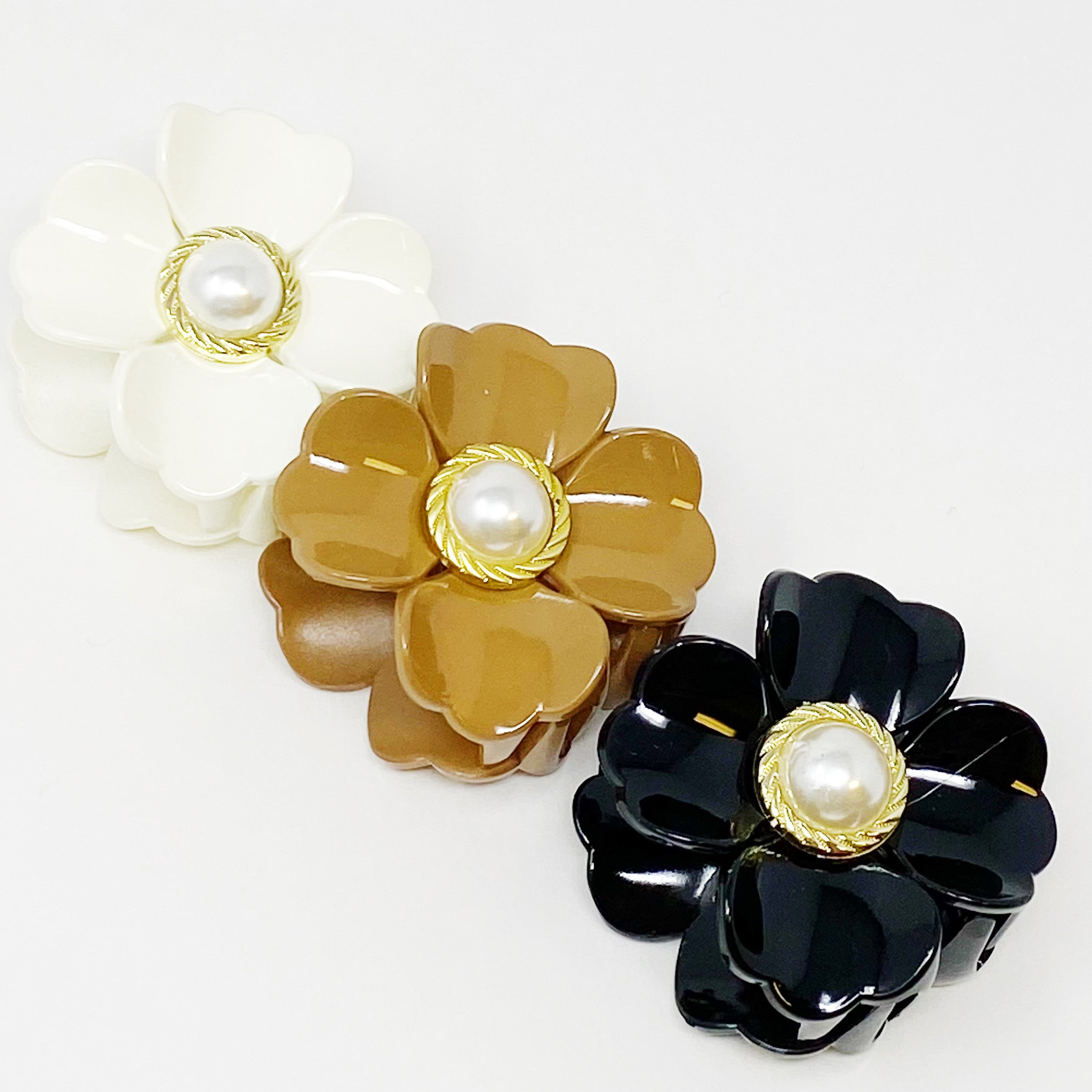 Loved By Coco Flower Hair Claw Set featuring three elegant hair claws with pearl-centered flowers in stylish color combinations.