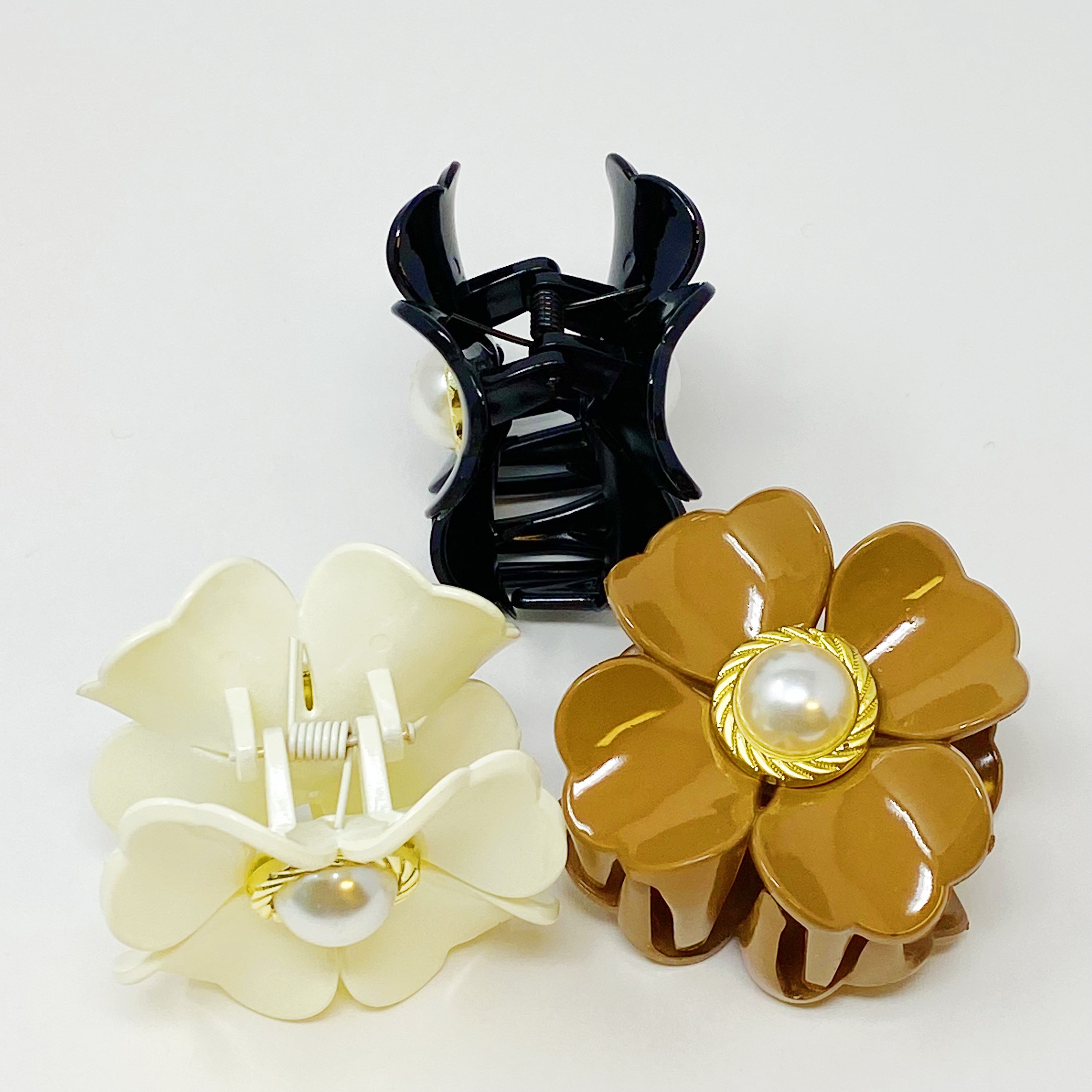 Loved By Coco Flower Hair Claw Set featuring three elegant hair claws with pearl-centered flowers in stylish color combinations.