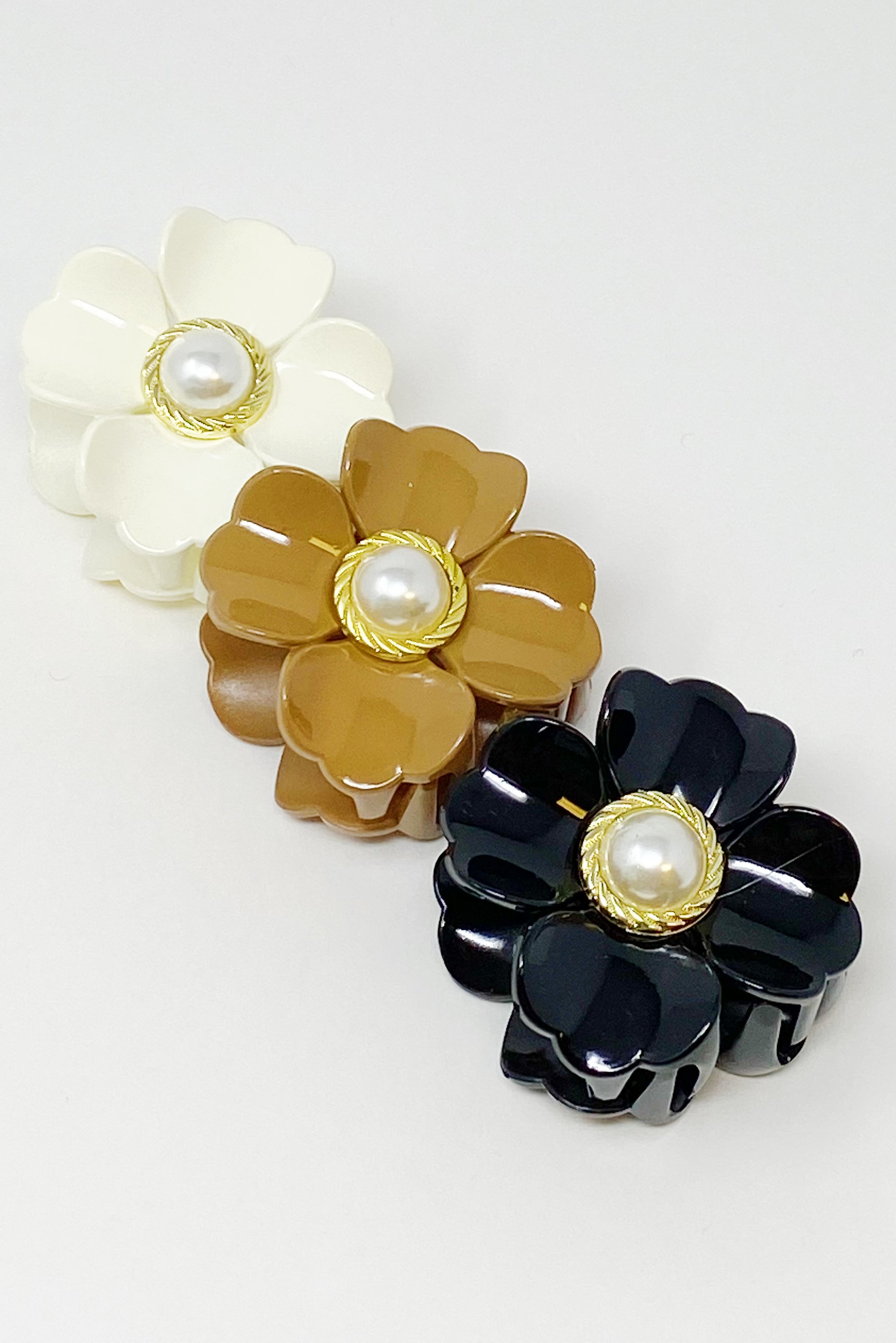 Loved By Coco Flower Hair Claw Set featuring three elegant hair claws with pearl-centered flowers in stylish color combinations.