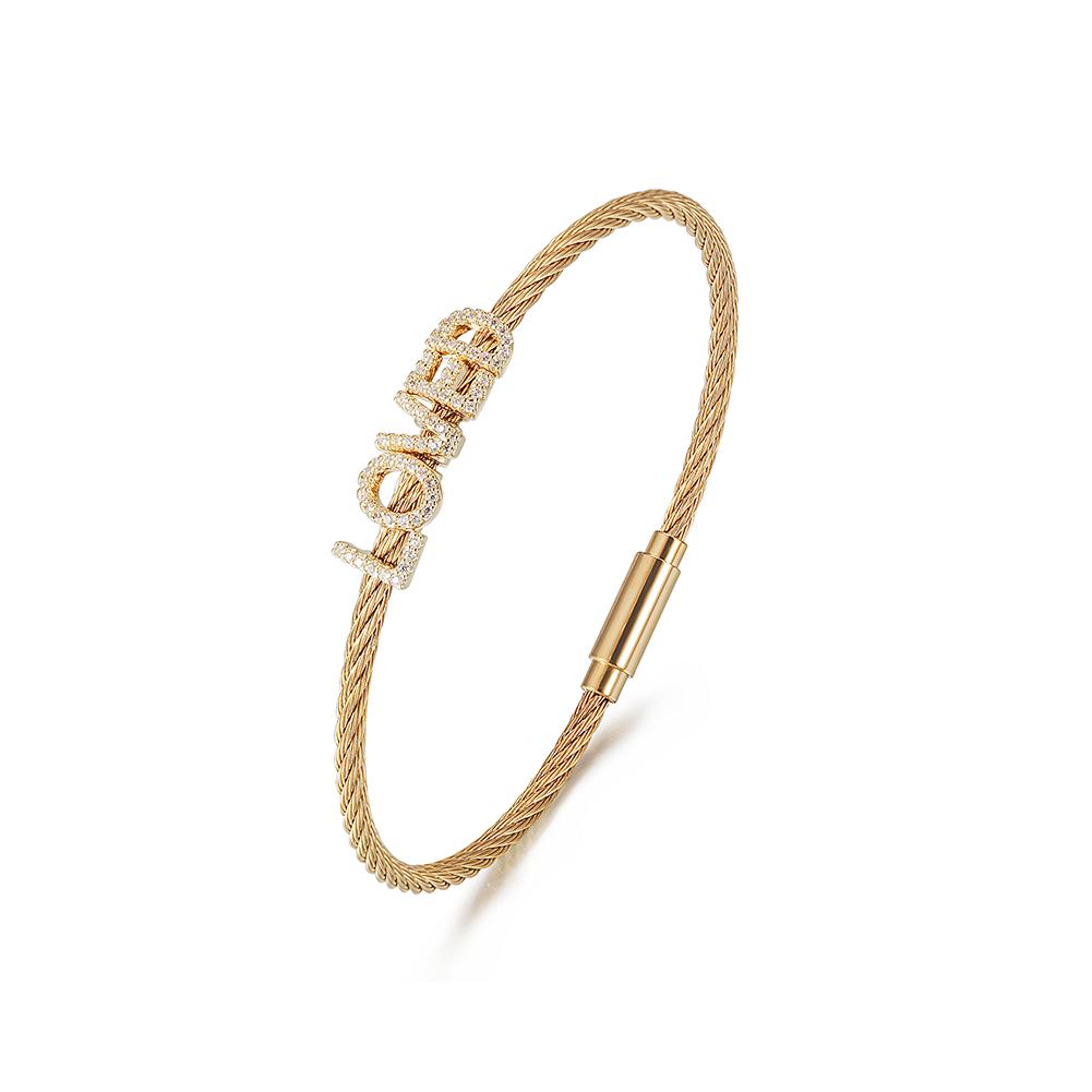 A beautiful 'LOVED' Pavé Bangle Bracelet made of surgical stainless steel with 14K gold plating, featuring a sparkling pavé design.