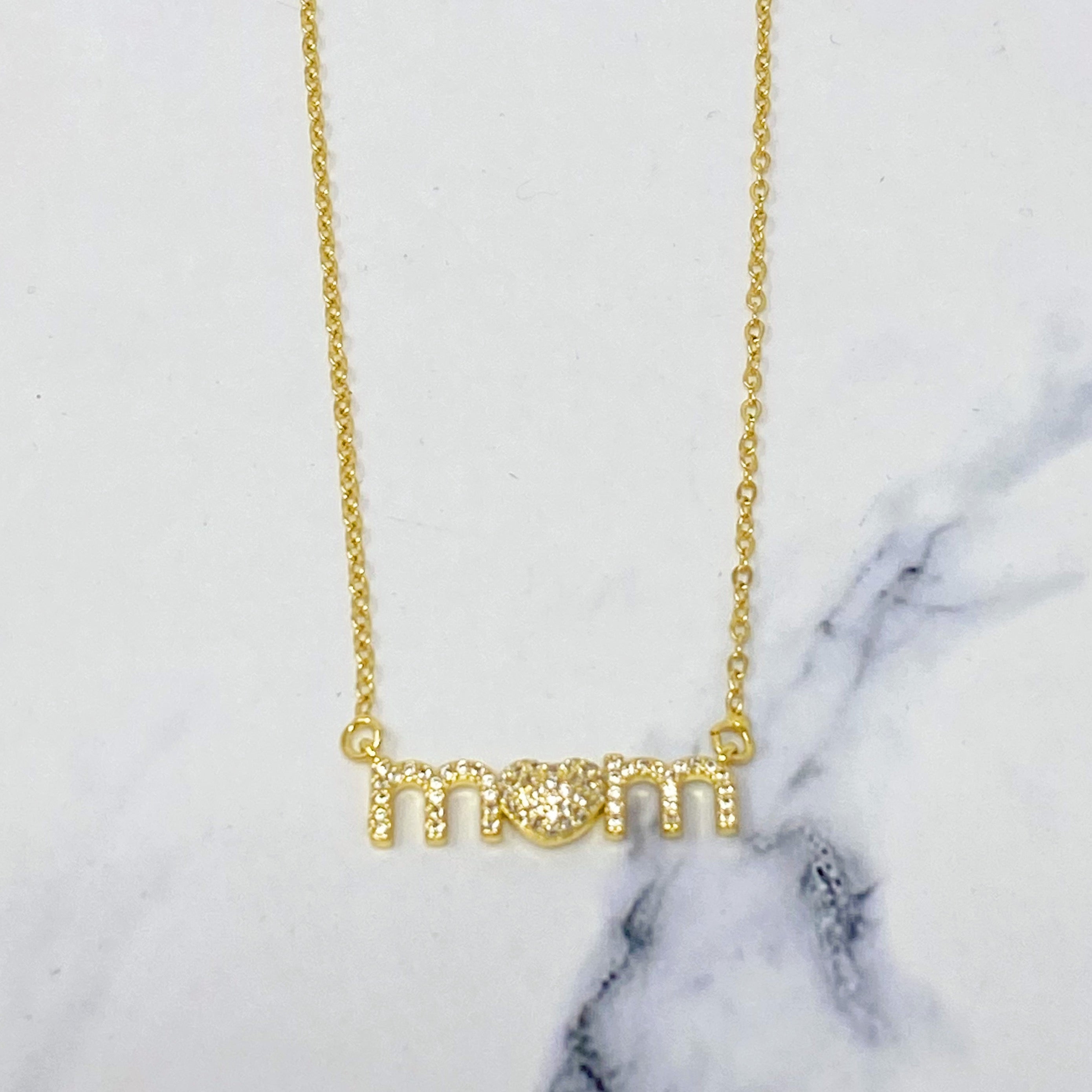 Lovely Mom Necklace featuring a heart-shaped pendant replacing the 'o' in 'mom', crafted from stainless steel and brass.