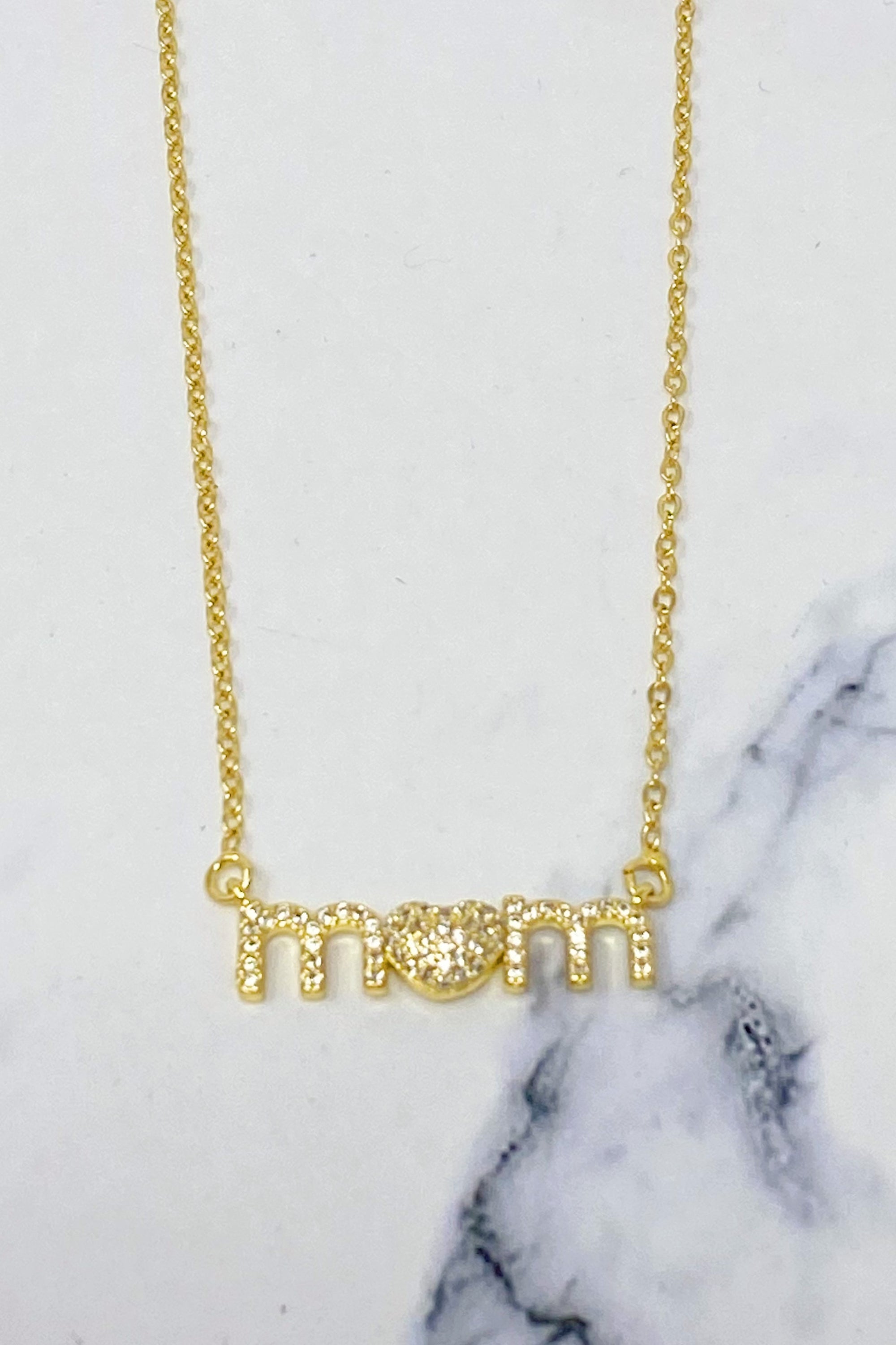 Lovely Mom Necklace featuring a heart-shaped pendant replacing the 'o' in 'mom', crafted from stainless steel and brass.