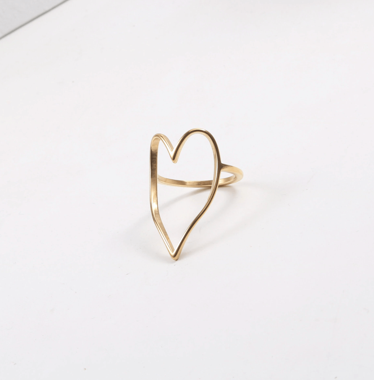 Lovestruck Open Heart Ring featuring a delicate heart design in stainless steel with 18Kt yellow gold PVD plating.