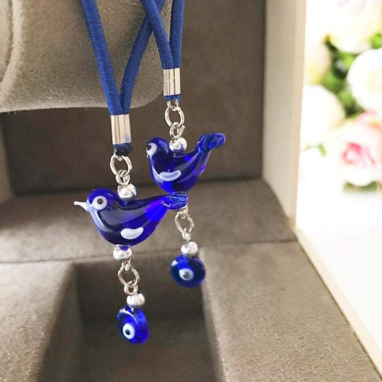 Handmade Lucky Bird car rear view mirror charm featuring glass bird and evil eye beads, perfect for car decoration.