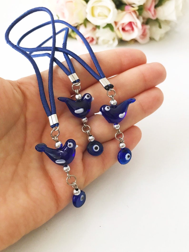 Handmade Lucky Bird car rear view mirror charm featuring glass bird and evil eye beads, perfect for car decoration.