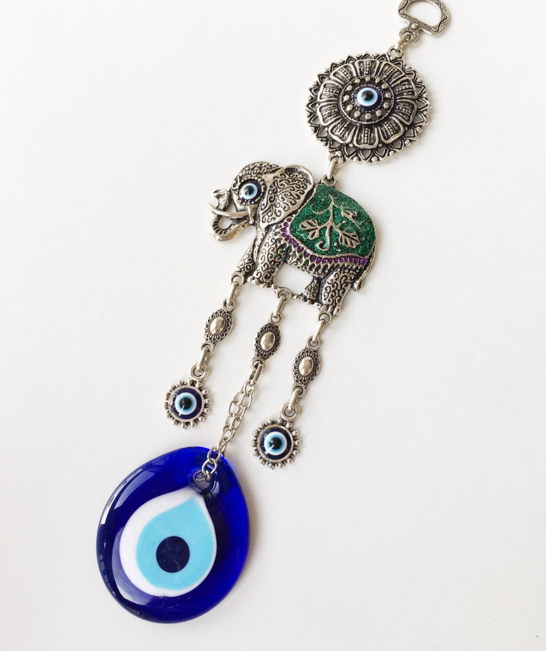 Handmade Lucky Elephant Evil Eye Wall Hanging featuring a blue evil eye bead and an elephant design, symbolizing protection and good luck.