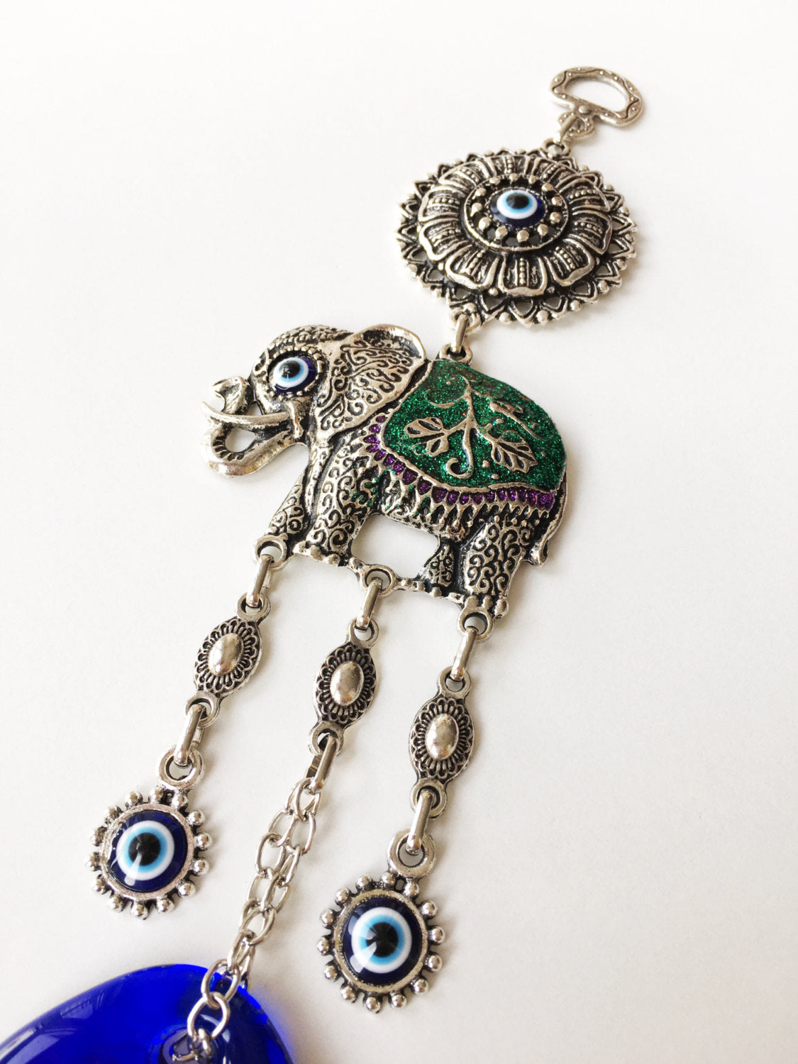 Handmade Lucky Elephant Evil Eye Wall Hanging featuring a blue evil eye bead and an elephant design, symbolizing protection and good luck.