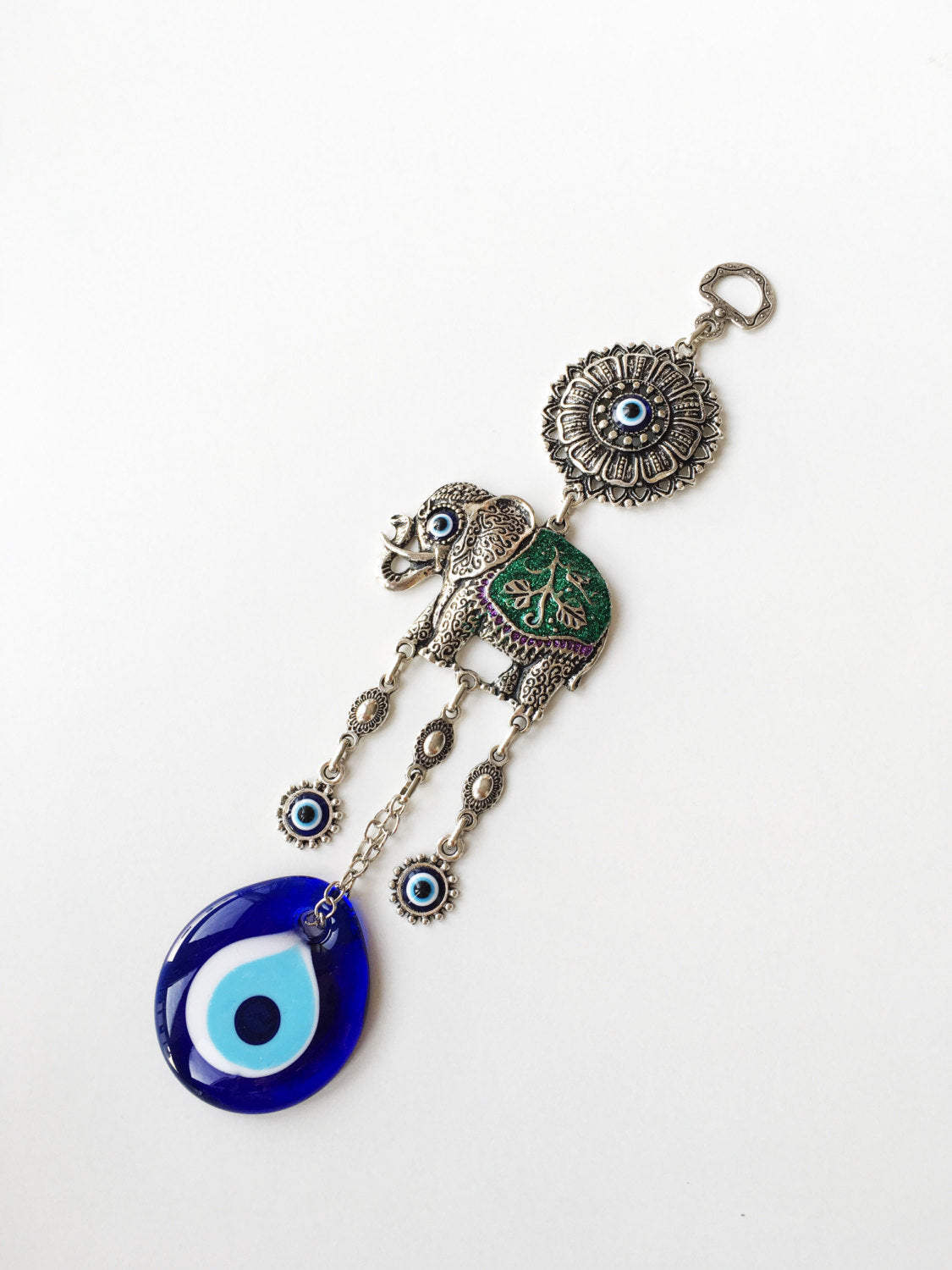 Handmade Lucky Elephant Evil Eye Wall Hanging featuring a blue evil eye bead and an elephant design, symbolizing protection and good luck.