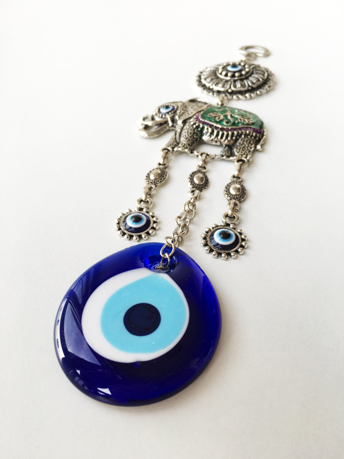 Handmade Lucky Elephant Evil Eye Wall Hanging featuring a blue evil eye bead and an elephant design, symbolizing protection and good luck.