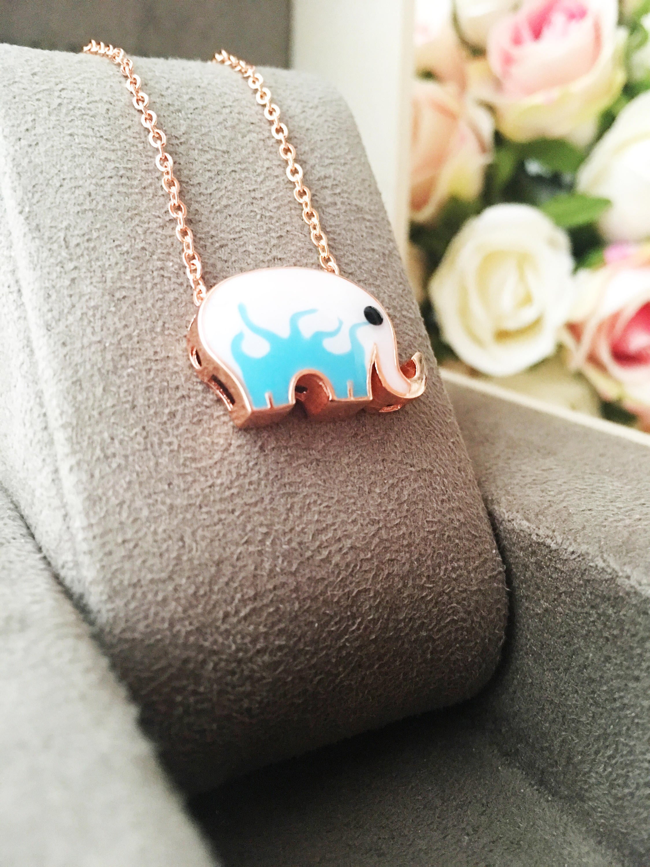 Handmade Lucky Elephant Necklace featuring a blue elephant charm and an evil eye pendant on a stainless steel chain.