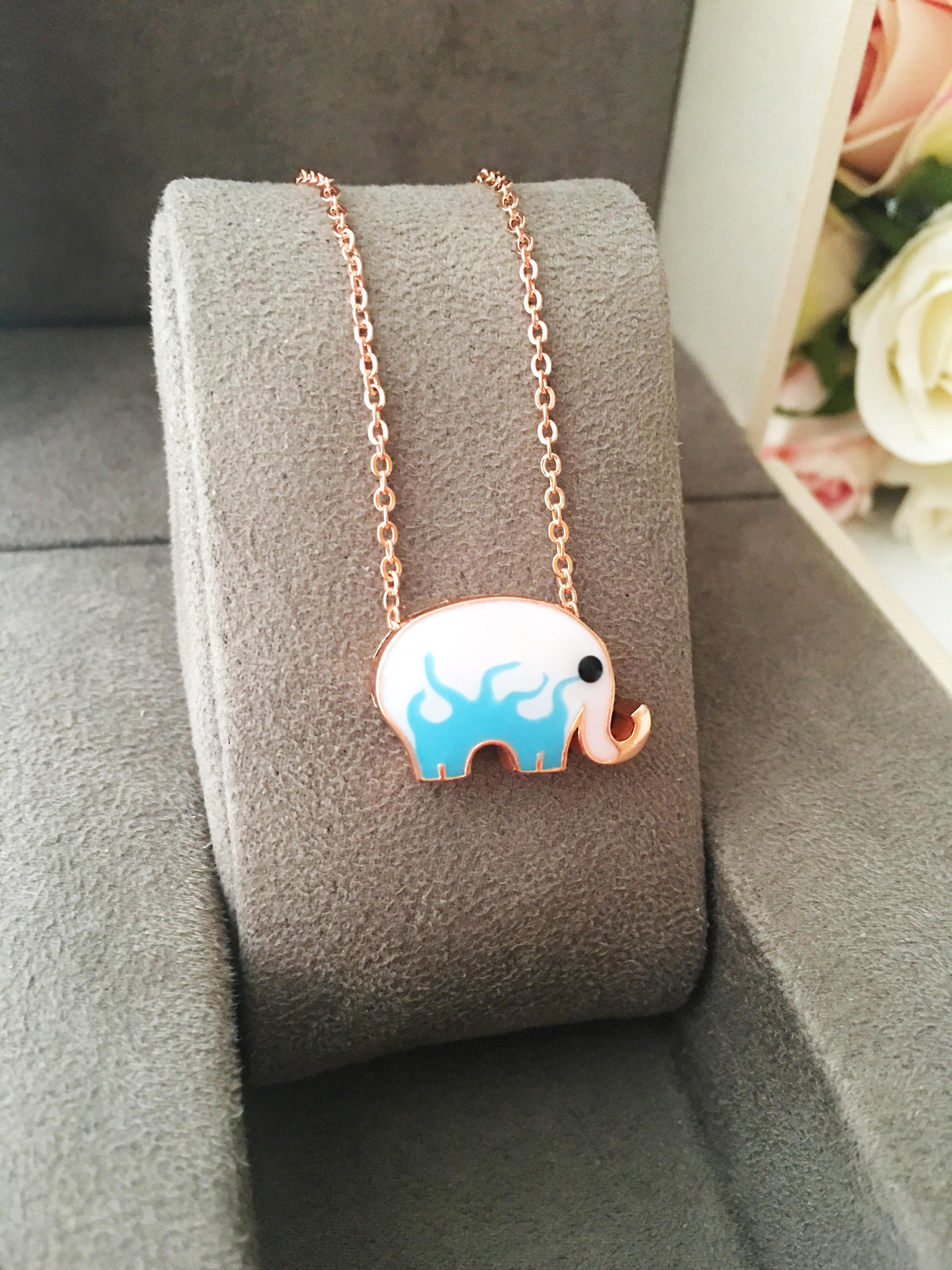 Handmade Lucky Elephant Necklace featuring a blue elephant charm and an evil eye pendant on a stainless steel chain.