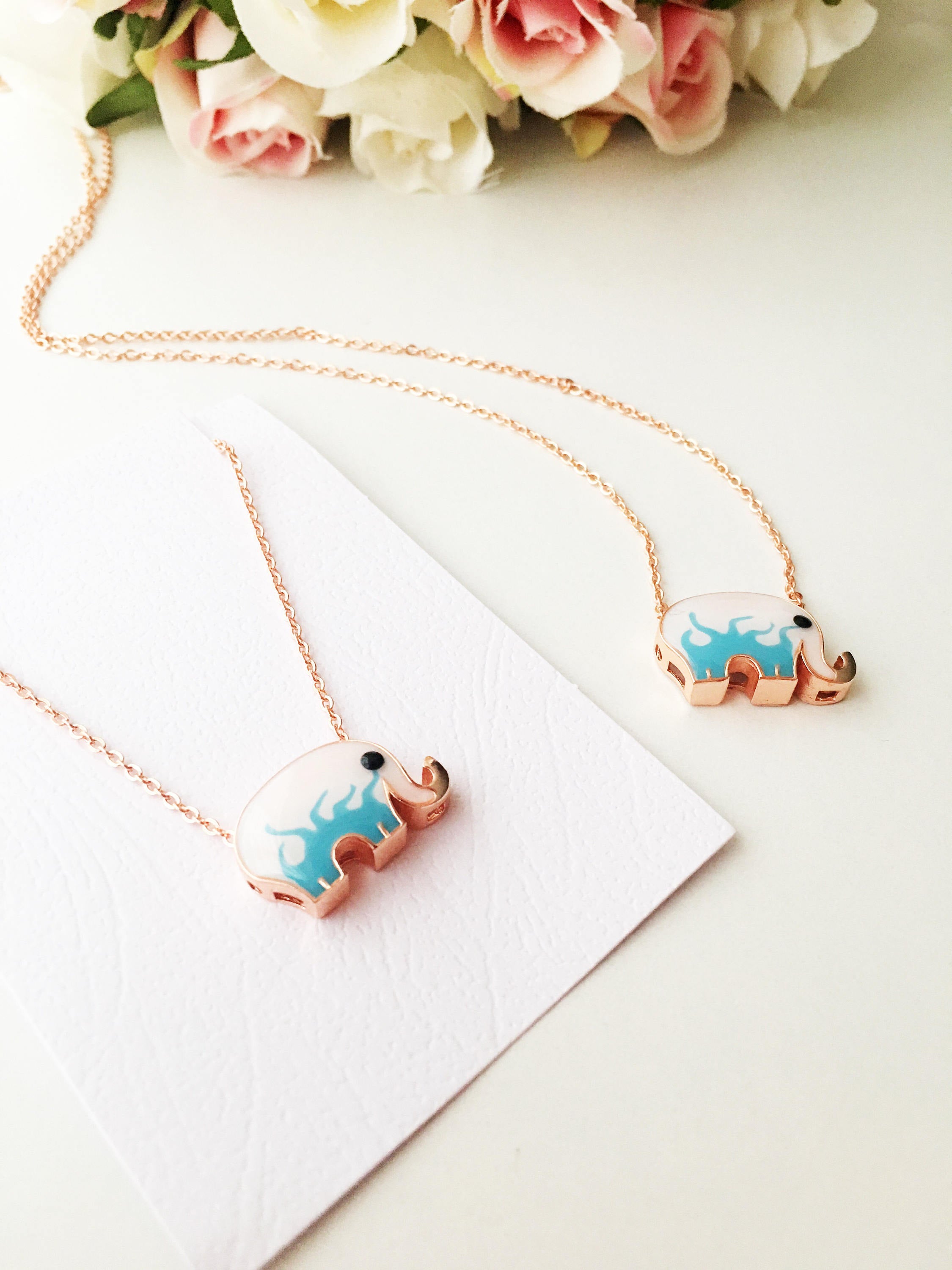 Handmade Lucky Elephant Necklace featuring a blue elephant charm and an evil eye pendant on a stainless steel chain.