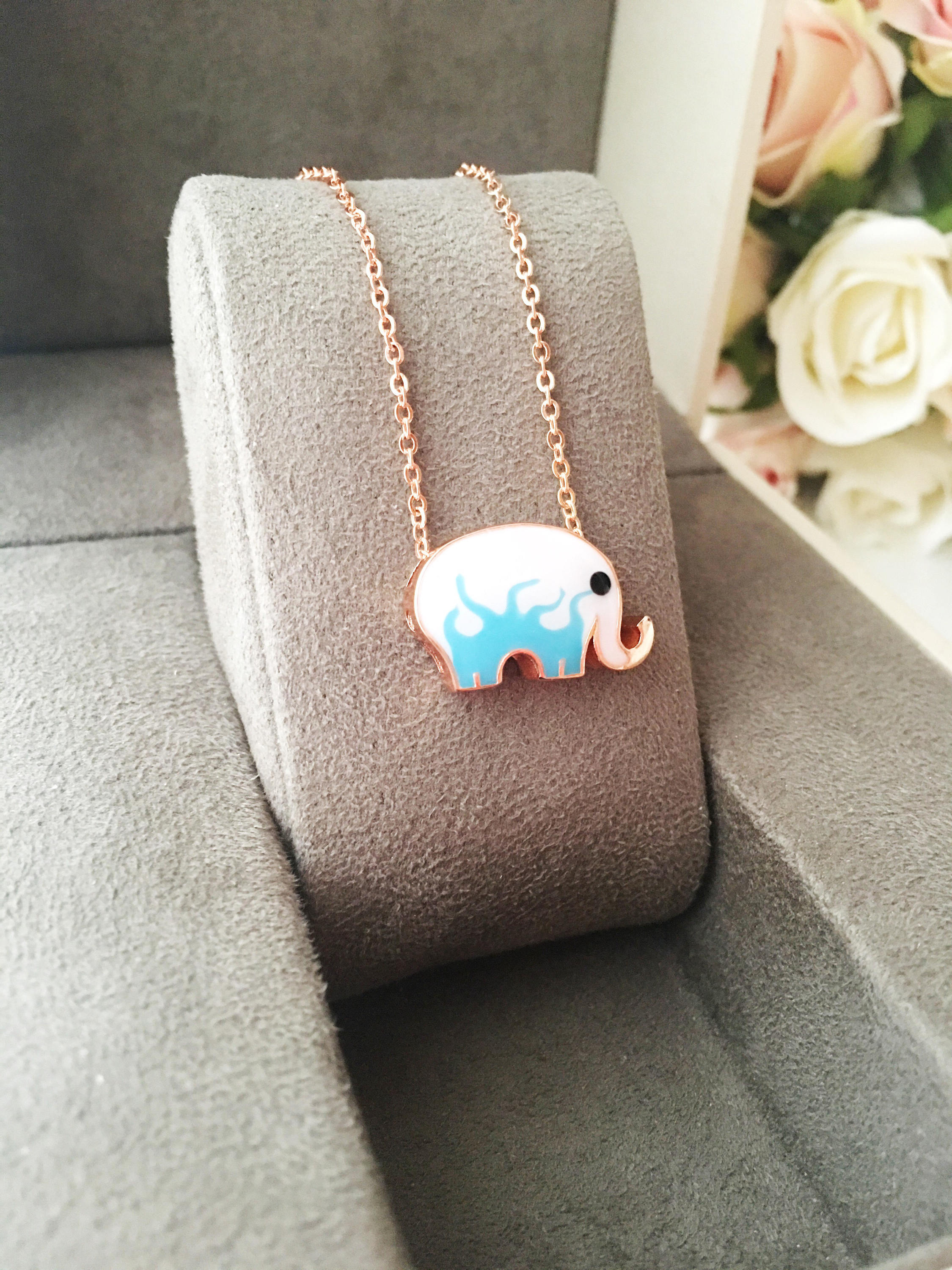 Handmade Lucky Elephant Necklace featuring a blue elephant charm and an evil eye pendant on a stainless steel chain.