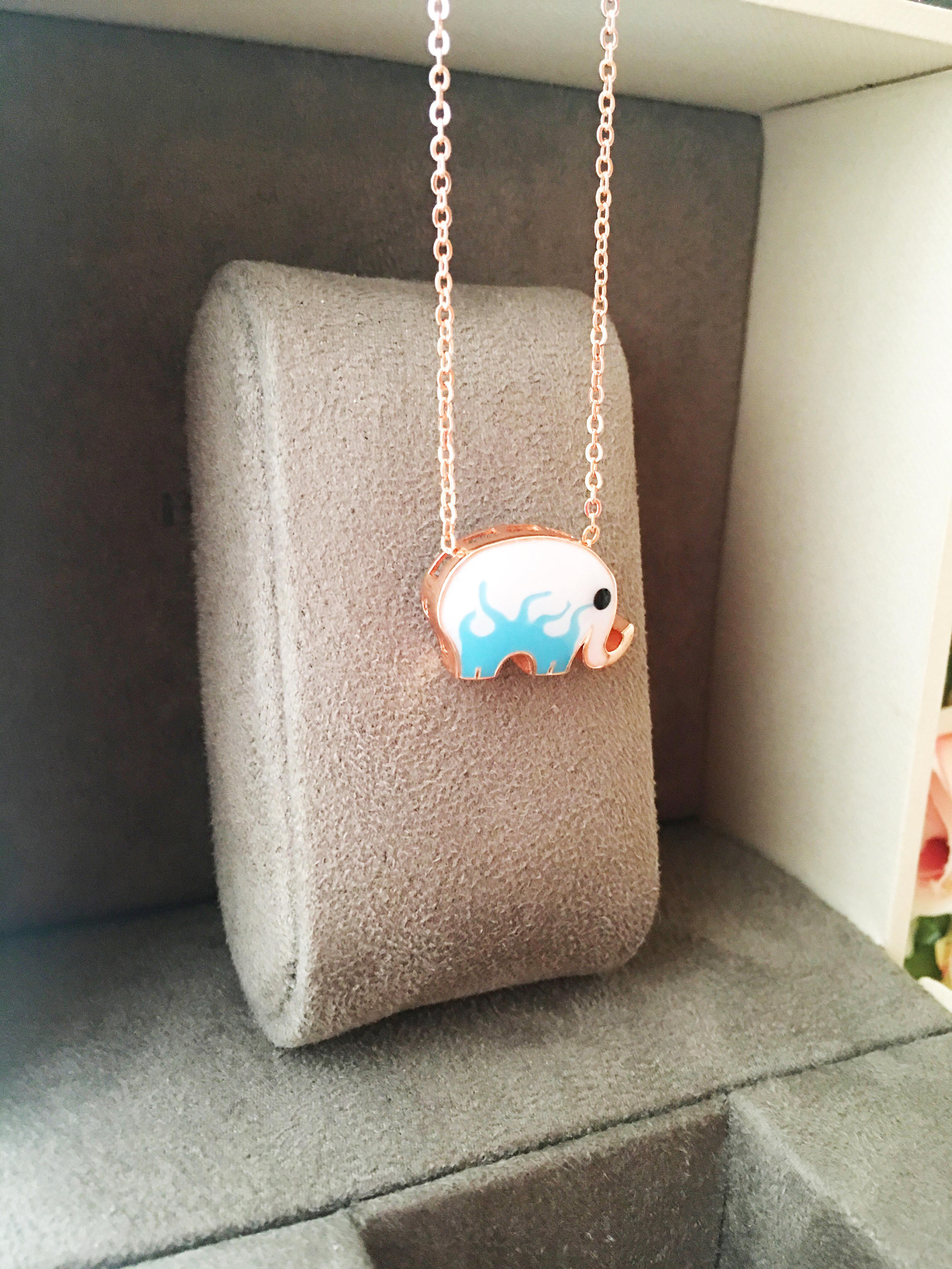 Handmade Lucky Elephant Necklace featuring a blue elephant charm and an evil eye pendant on a stainless steel chain.