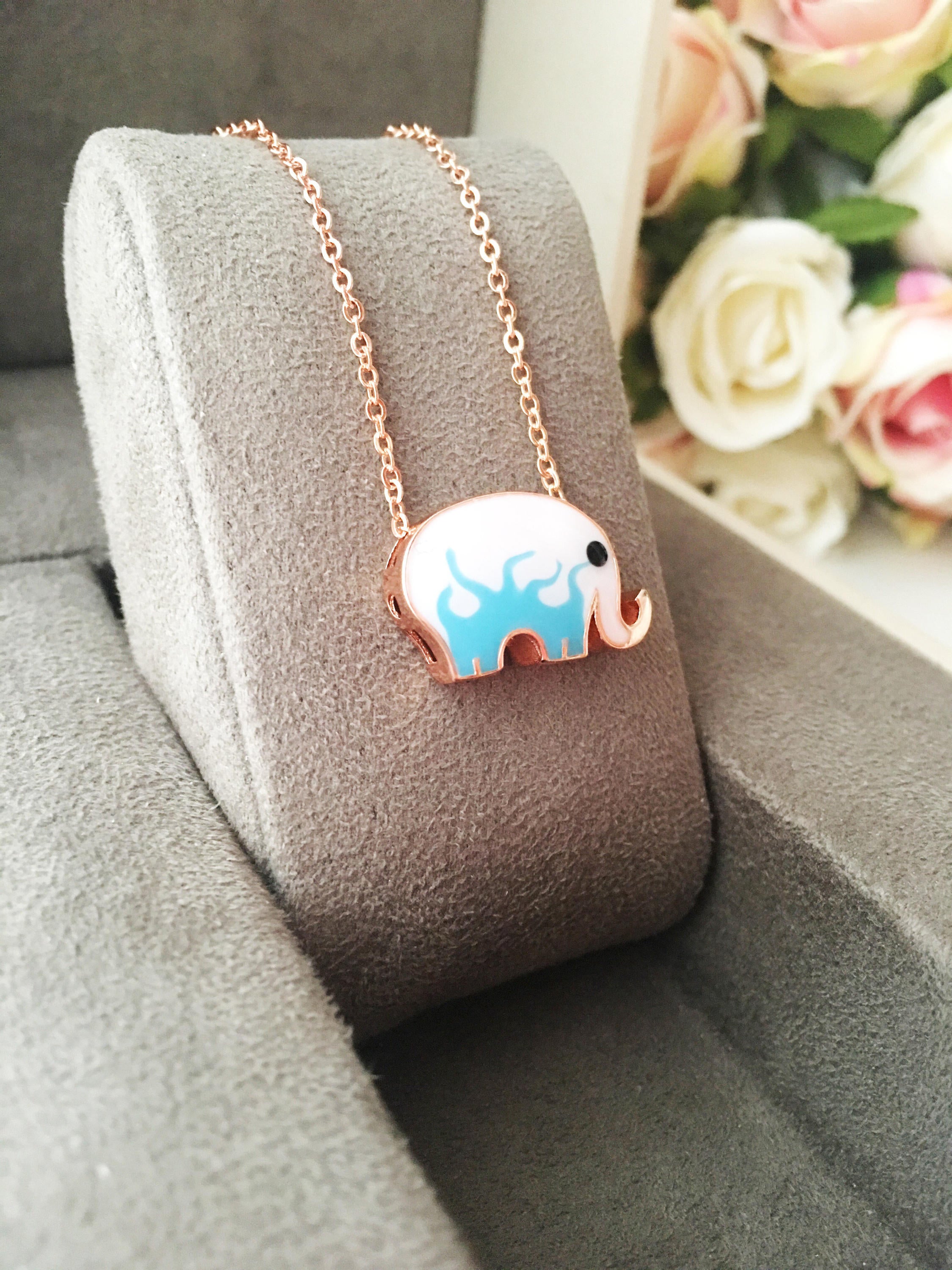 Handmade Lucky Elephant Necklace featuring a blue elephant charm and an evil eye pendant on a stainless steel chain.