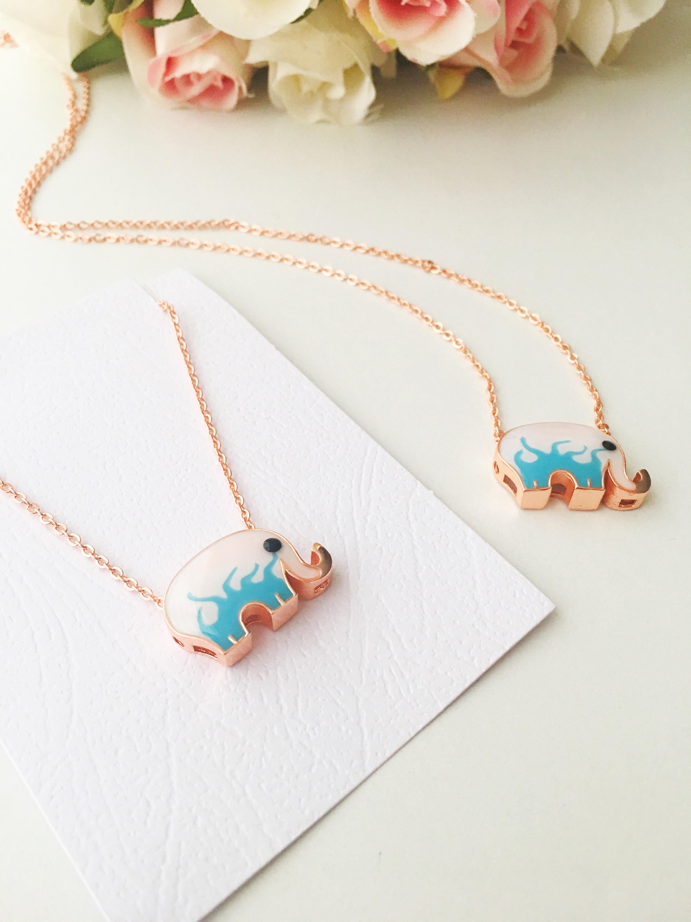 Handmade Lucky Elephant Necklace featuring a blue elephant charm and an evil eye pendant on a stainless steel chain.