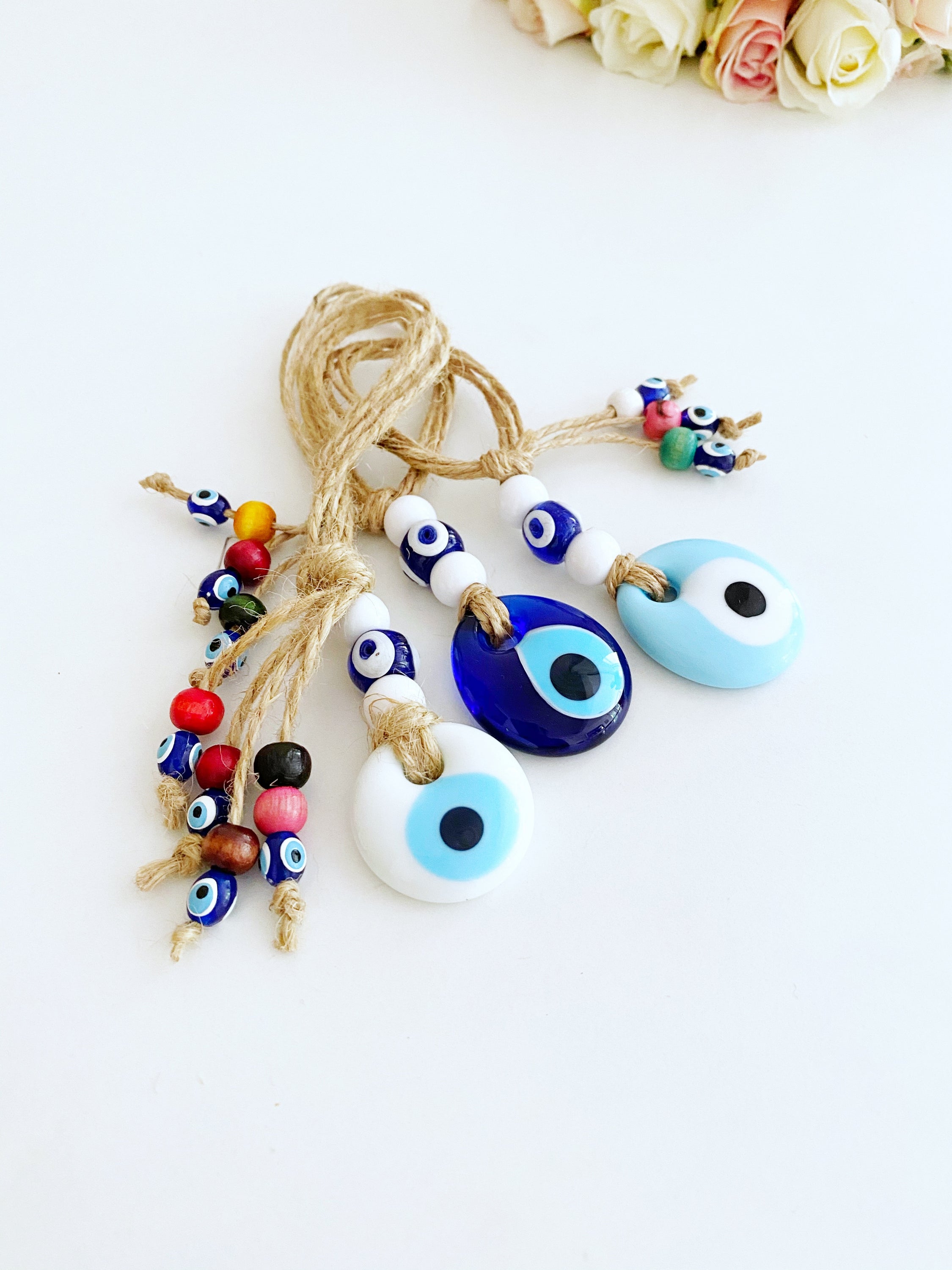 Handmade Lucky Evil Eye Bead charm for car rearview mirror, featuring a white evil eye bead and colorful glass beads.