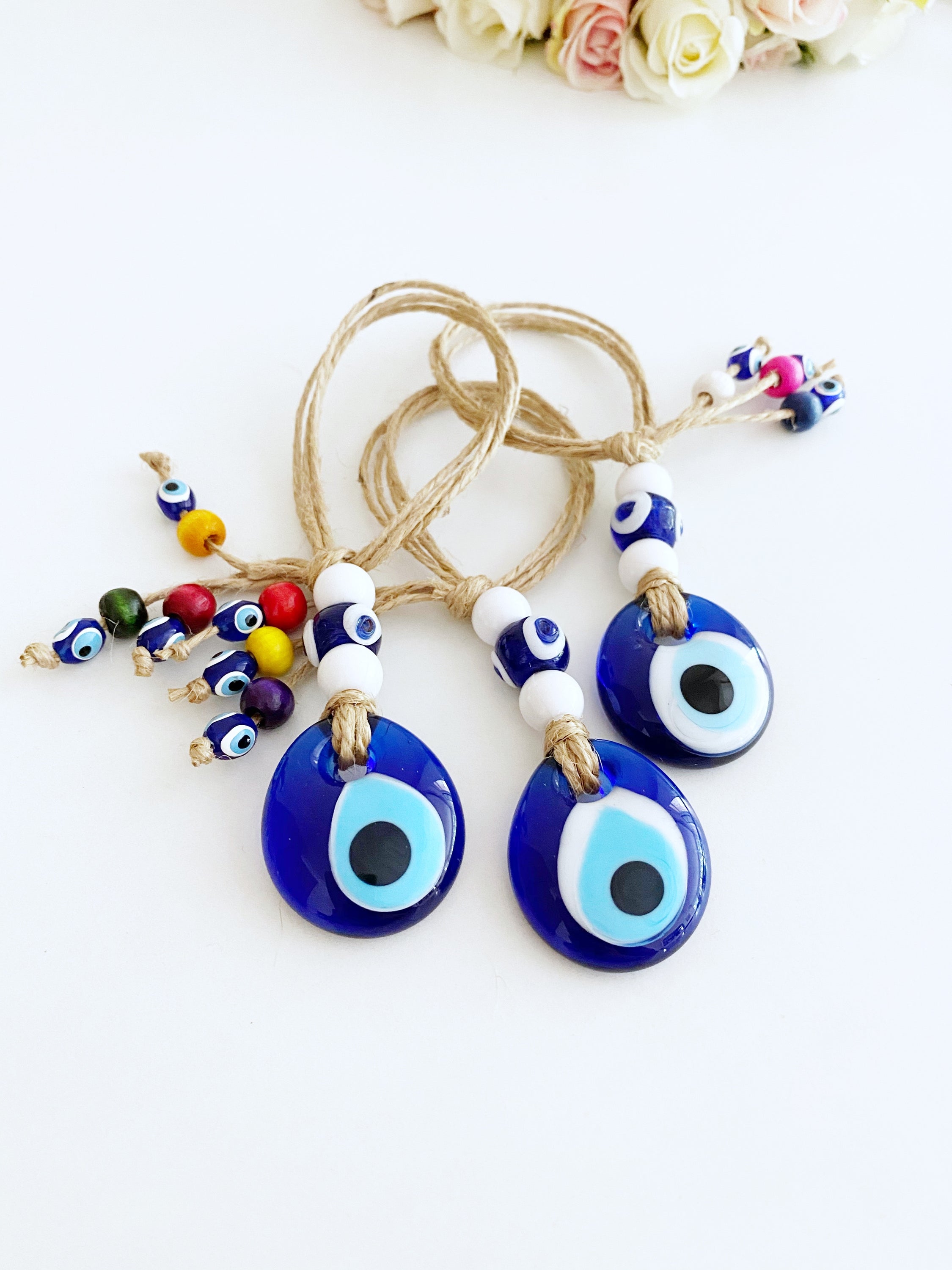 Handmade Lucky Evil Eye Bead charm for car rearview mirror, featuring a white evil eye bead and colorful glass beads.