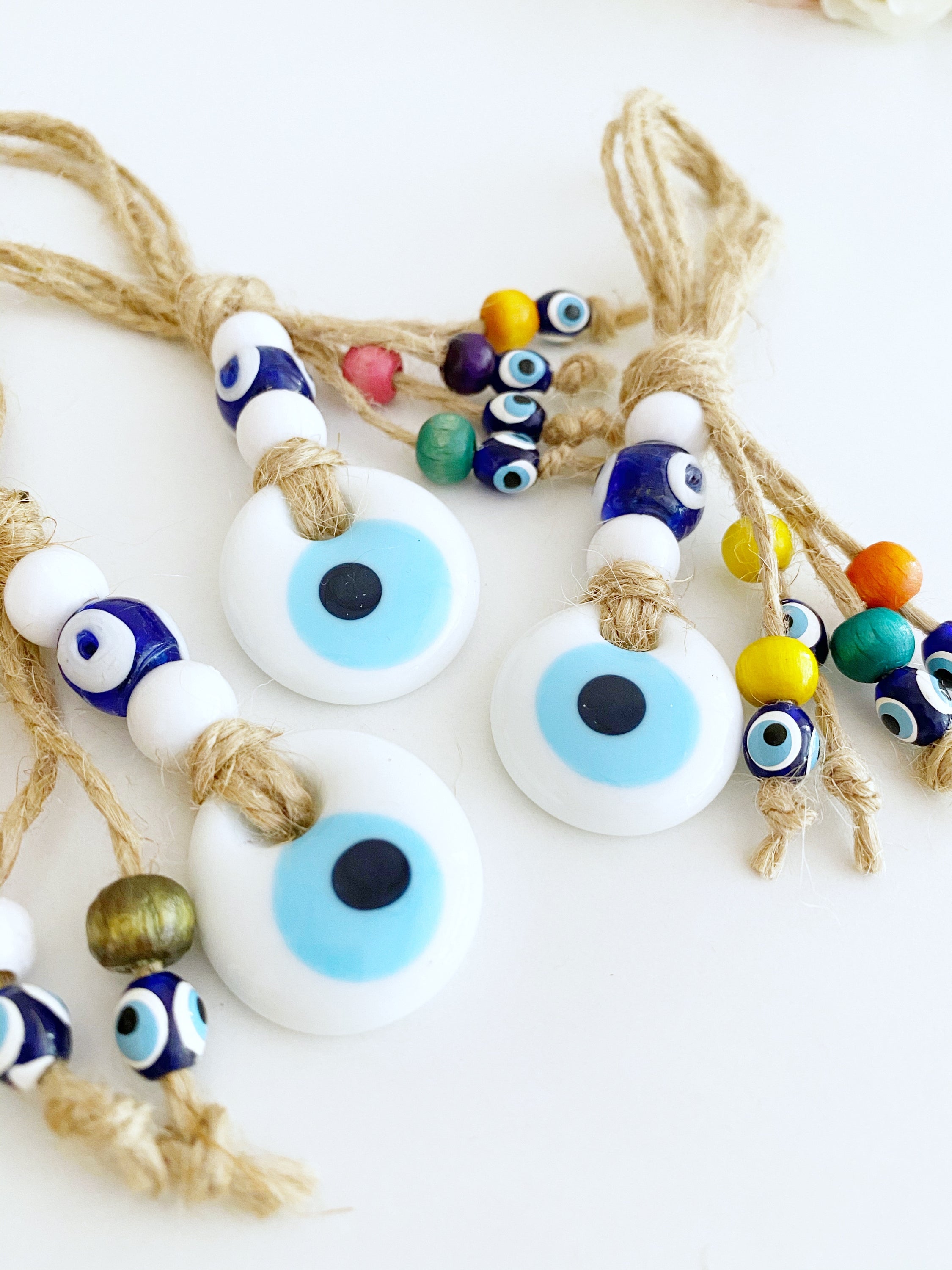 Handmade Lucky Evil Eye Bead charm for car rearview mirror, featuring a white evil eye bead and colorful glass beads.